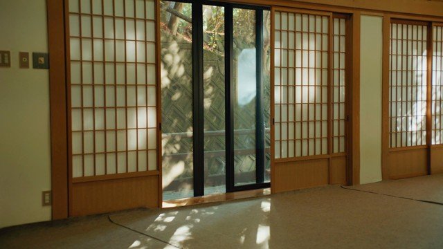 An open shoji threshold joining interior and exterior light